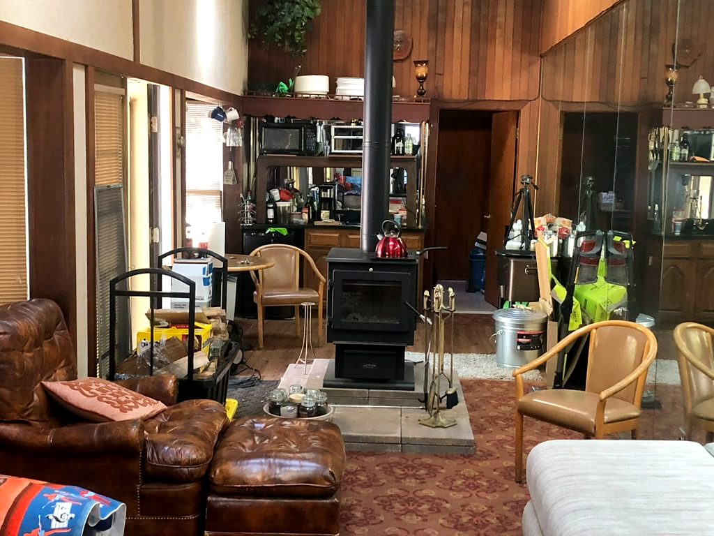 Lounge with cathedral ceiling and wood stove